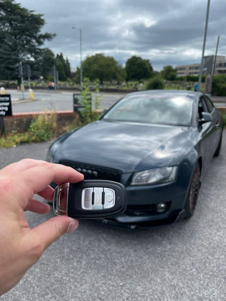 a hand holding a car key